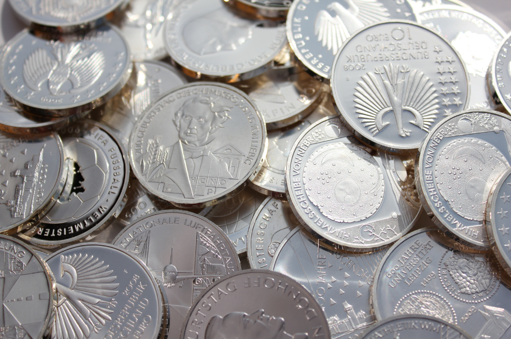 Modern commemorative silver coins with detailed designs, valued by professional Coin Buyers in College Station.